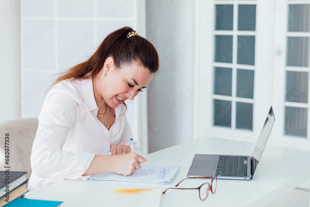 Business woman at work in office with laptop at desk Business woman at work in office with laptop at desk