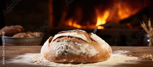 In a traditional Countryn bakery, a fresh batch of white bread is being baked to perfection, creating a home-made, brown loaf with a round shape. photo