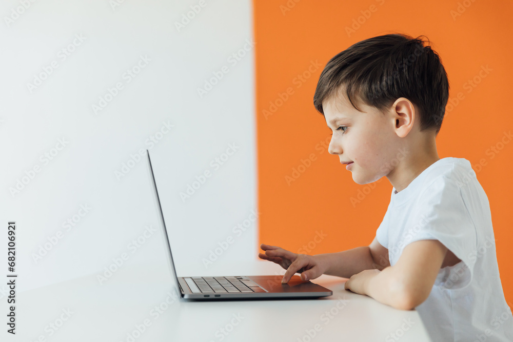 Smart Young Boy Works on a Laptop For His New Project in His Computer Science Class. Smart Young Boy Works on a Laptop For His New Project in His Computer Science Class.