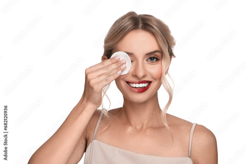 Smiling woman removing makeup with cotton pad on white background Smiling woman removing makeup with cotton pad on white background