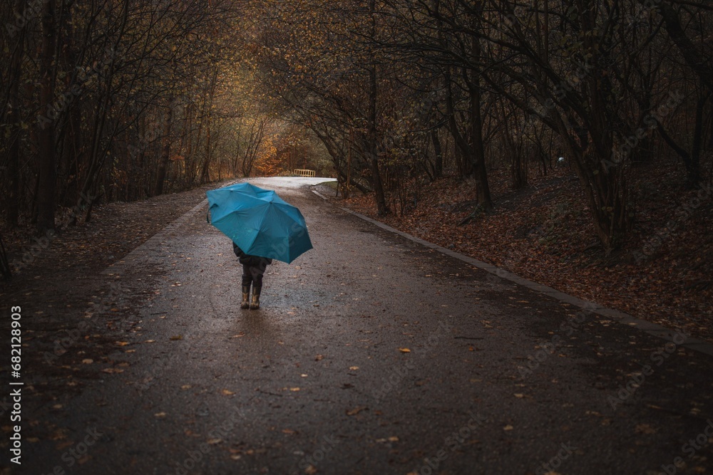 child walking in the rain