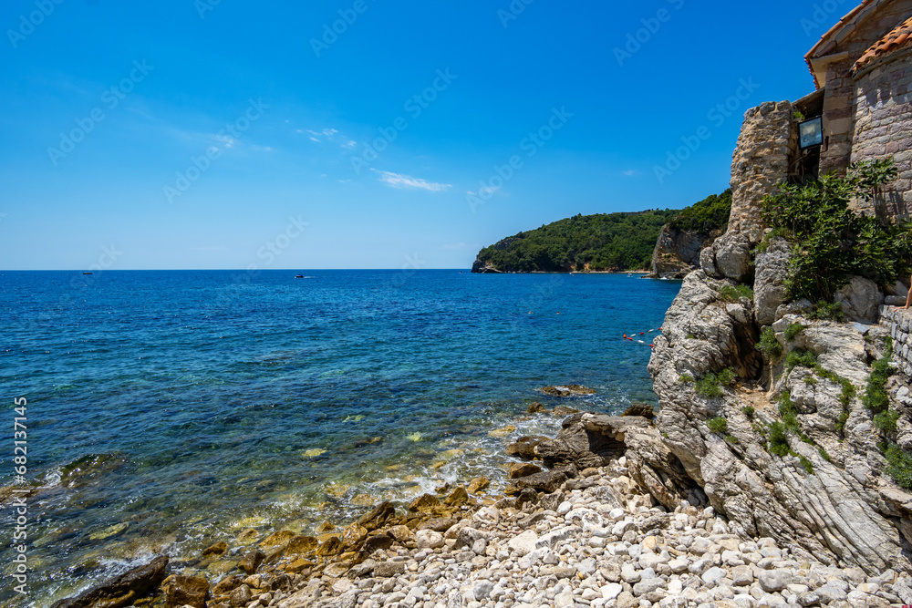 view of the fortress and the old town on the seashore and mountains, panorama of the Budva resort in Montenegro, Adriatic Sea, beaches, islands, tourism and summer travel