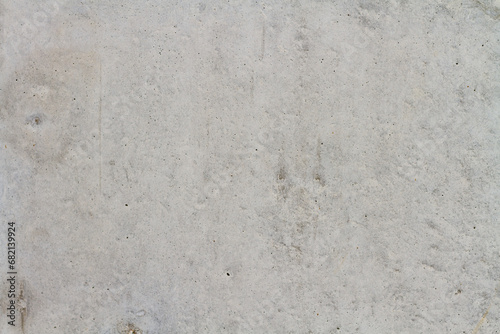 Texture of a gray concrete wall with small brown splashes. Background