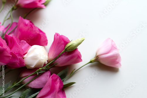 Beautiful bouquet of eustoma flowers on a white background. Fresh cut flowers in pastel white and pink colors. View from above. Soft focus