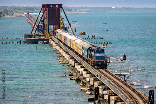 Indian Railways passenger train crossing historical , 2 kms long Pamban sea bridge. photo