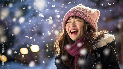 Close up portrait of Asian Woman happily screaming into falling snow
