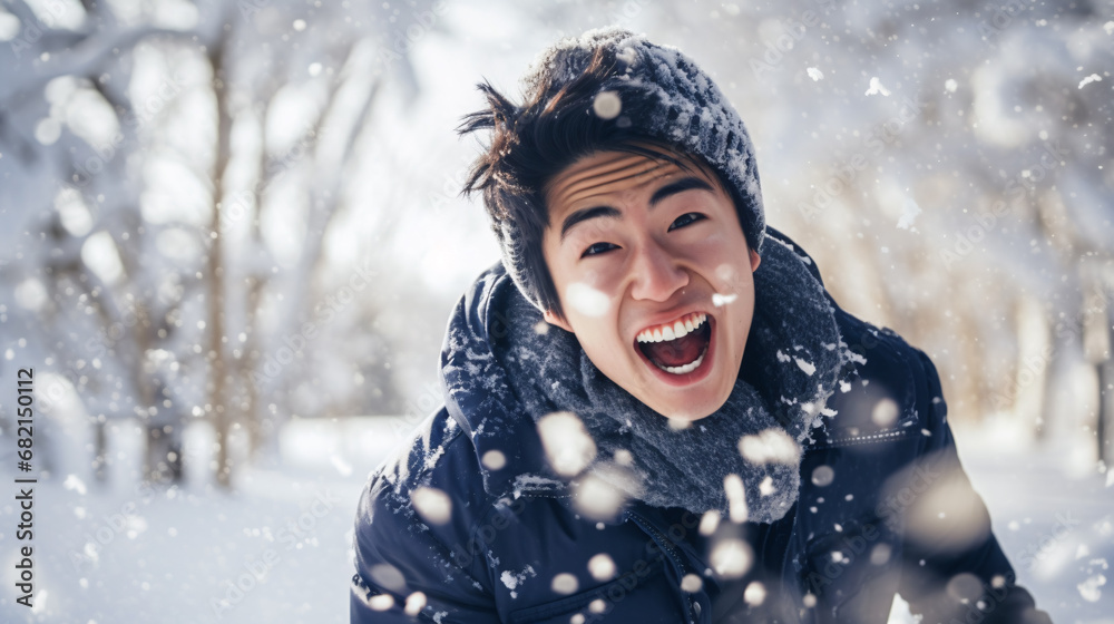 Close up portrait of Asian man happily screaming into falling snow Close up portrait of Asian man happily screaming into falling snow
