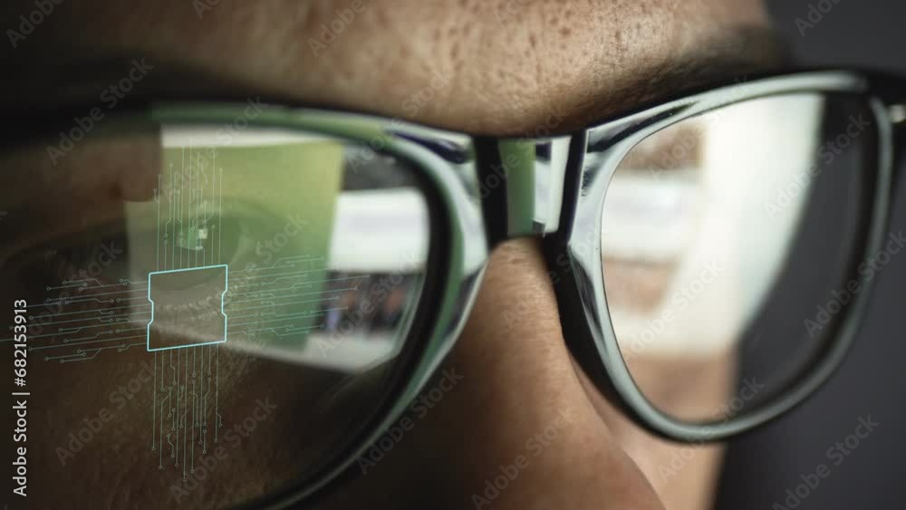 Processor scheme reflected on the glasses on a man's face. The idea of a digital future. Data concept.