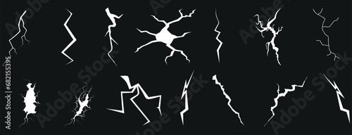 Crack, Fissure, Fracture Vector Illustration: Striking black background with white cracks, fissures, and fractures in various shapes and sizes. Perfect for conveying concepts of danger, destruction