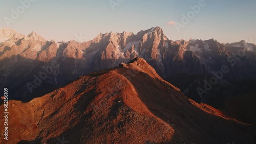 golden hour at mountain top Bivacco Pascal and testa licony. Mont Blanc massif on horizon, cinematic aerial shot photo