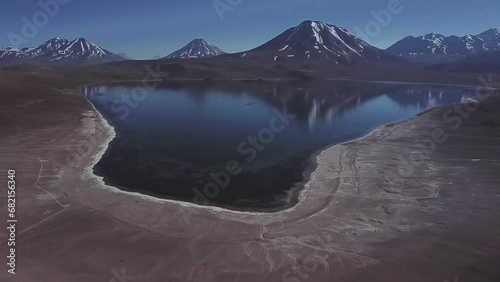 Lake Meniques on Los Flamencos National Reserve and Chile volcanos in the background, Antofagasta Region, Bolivia photo