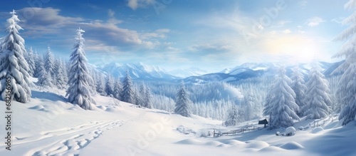 As he embarked on his travel journey through the winter landscape, his eyes were met with a breathtaking sight of snow-covered trees, a blue sky, and sun's rays glistening on the white mountains and © 2rogan