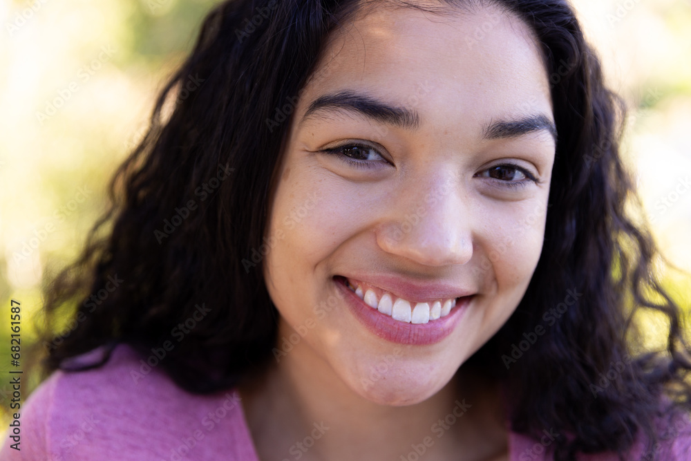 Close up portrait of happy biracial woman in sunny nature Close up portrait of happy biracial woman in sunny nature
