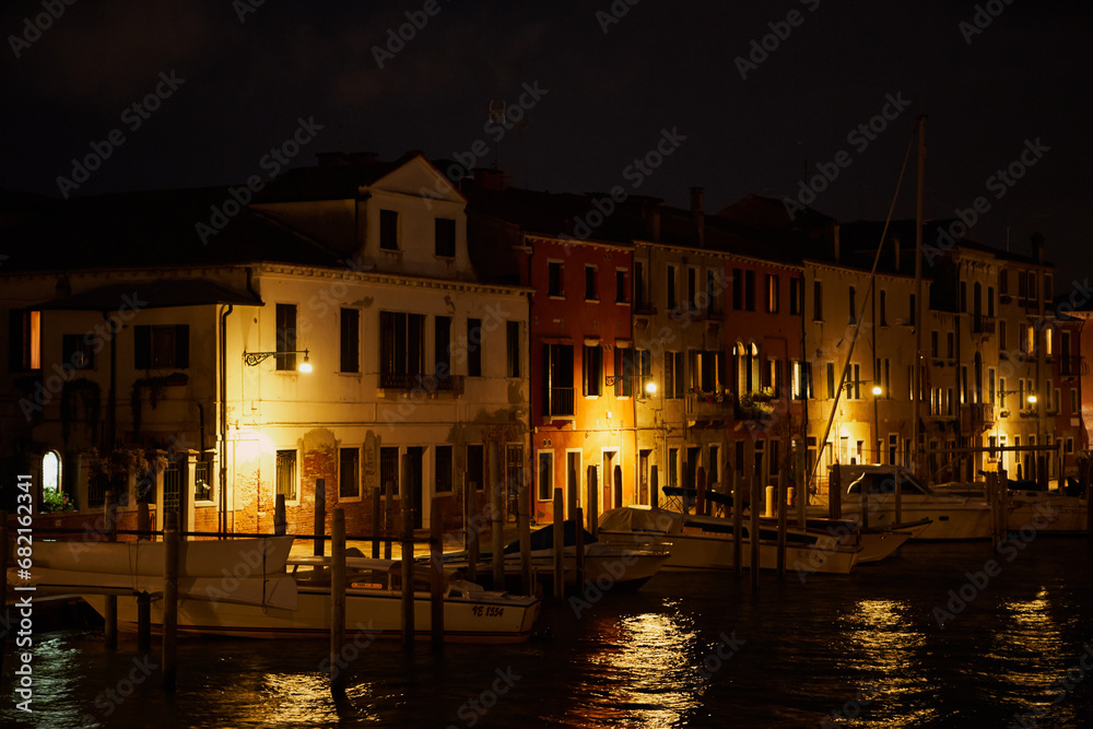 Old Venetian houses on the waterfront at night. Lower class residential area on Guidecca island. Venice - 4 May, 2019