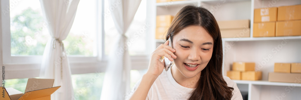 Business owner on the phone talking to a customer, Business owner taking orders from laptop, Packaging and Delivery, Packaging and Shipping. Business owner on the phone talking to a customer, Business owner taking orders from laptop, Packaging and Delivery, Packaging and Shipping.