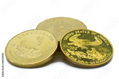 Krugerrand, United States gold eagle 50 dollar coin, and a bitcoin. photo