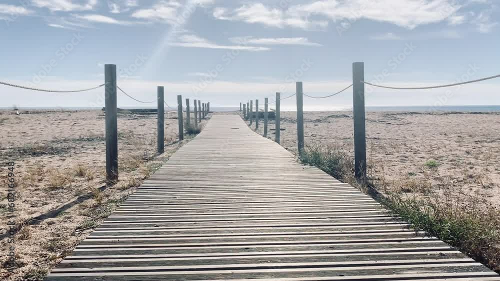 Wooden path on the beach to reach the sea. Wooden path on the beach to reach the sea.