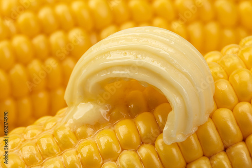 Butter melts on corn cobs.