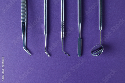 Dental tools on violet background