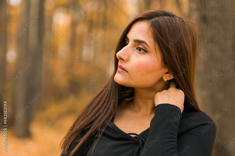 Beautiful indian woman generation z relaxing and feeling nature at autumn park in fall season. Diversity and gen z youth Beautiful indian woman generation z relaxing and feeling nature at autumn park in fall season. Diversity and gen z youth