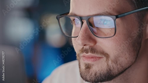 Close up shot of man eyeglasses reflection graphic analysis. Businessman interested touching chin when seeing world global crypto market big changes. Cryptocurrency trends