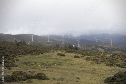Alignment of wind turbines on hill - Wind turbines align on a hill, creating a striking visual in the landscape of Monte Nomedio, shot with the Sony RX100 in Galicia.