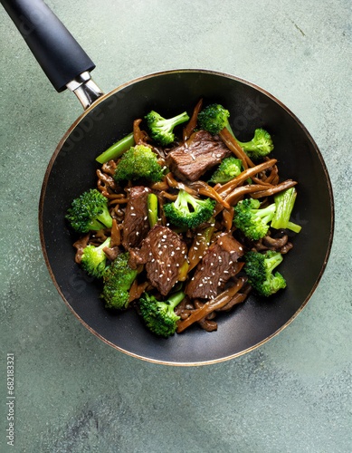 Beef and broccoli with sesame seeds cooked in a wok. Stir fry Asian food. photo