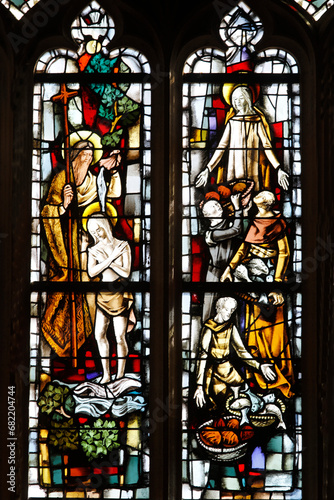St Nicolas's church, Beaumont le Roger, Eure, France. Stained glass detail showing Jesus's baptism and the miracle at Cana.