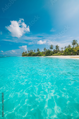 Beautiful tropical beach. Sea waves white sand, palm trees, turquoise ocean against sunny blue sky clouds happy summer day. Perfect landscape background for relaxing vacation, amazing Maldives travel