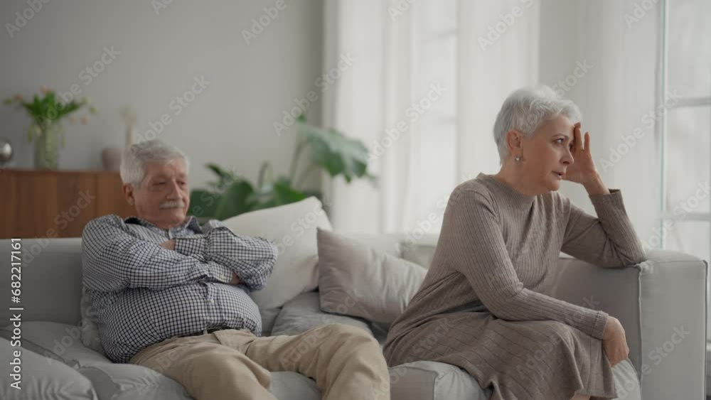 Senior sad couple separate on couch ignoring each other, avoid talking after fight and quarrel. Wife and husband have misunderstandings, experiencing relationship crisis. Upset elderly family at home. Senior sad couple separate on couch ignoring each other, avoid talking after fight and quarrel. Wife and husband have misunderstandings, experiencing relationship crisis. Upset elderly family at home.
