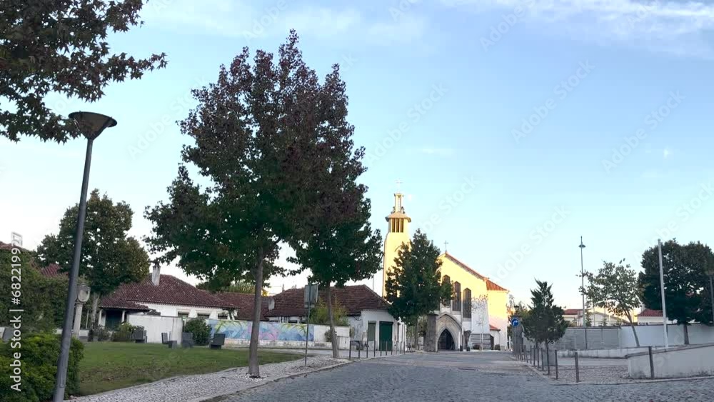 Daytime scene of empty street with view, park walking area with trees on one side and religious church building visible. Daytime scene of empty street with view, park walking area with trees on one side and religious church building visible.