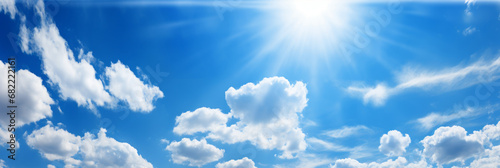 Heaven of blue sky, sun and clouds. Panoramic banner. Copy space where you can easily insert text such as advertisements. photo