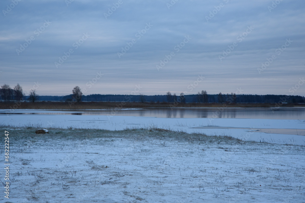 lightly snow-covered lake during the first frost lightly snow-covered lake during the first frost