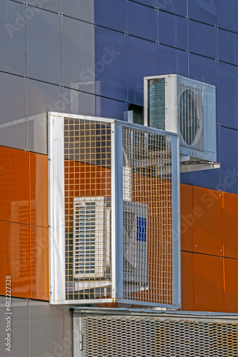 The air conditioning equipment is mounted on the wall on an autumn day