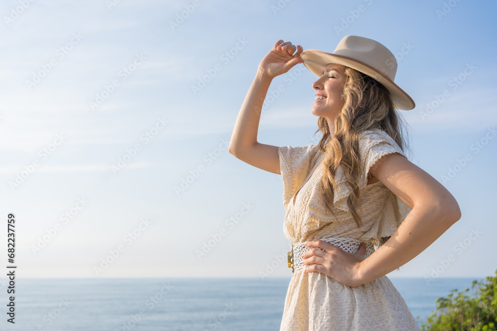 Stylish woman in summer clothes gazing the sea