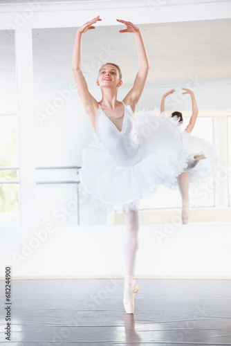 Smile, dance and teen student in ballet studio with pose, balance and performance class for teenager. Movement, talent and young ballerina dancer with pride, confidence and creative show at academy.