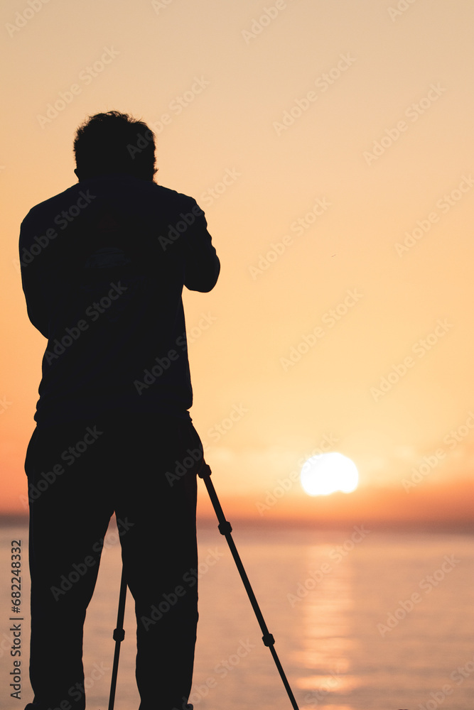 silhouette of a photographer at sunrise