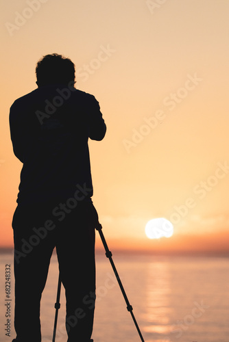 silhouette of a photographer at sunrise