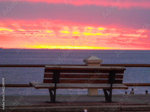 sunset on the promenade wooden bench