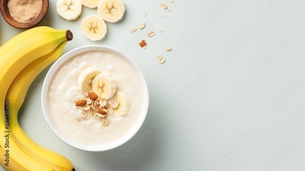 A bowl of creamy oatmeal with sliced banana, honey, and chopped walnuts - obrazy, fototapety, plakaty 