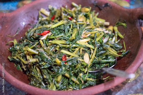 Stir-fried water spinach is a common Asian vegetable dish, known by various names in Asian languages. Water spinach or Ipomoea aquatica is stir-fried with a variety of vegetables, spices, meats