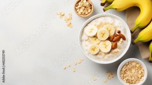 A bowl of creamy oatmeal with sliced banana, honey, and chopped walnuts photo