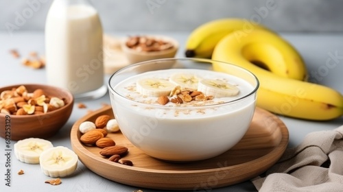 A bowl of creamy oatmeal with sliced banana, honey, and chopped walnuts