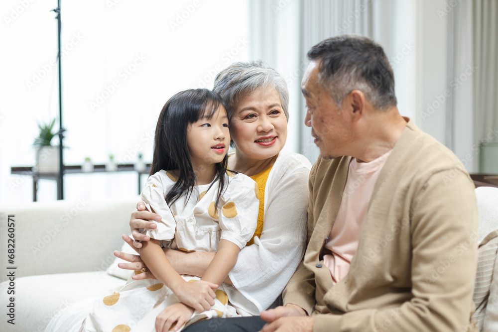 Happy Family Grandfather Grandmother and Granddaughter having fun living room at home. connects relationships different ages. Relax Time children with parents, Family Happiness Concept. Happy Family Grandfather Grandmother and Granddaughter having fun living room at home. connects relationships different ages. Relax Time children with parents, Family Happiness Concept.