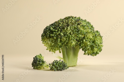 Fresh raw broccoli on beige background, closeup