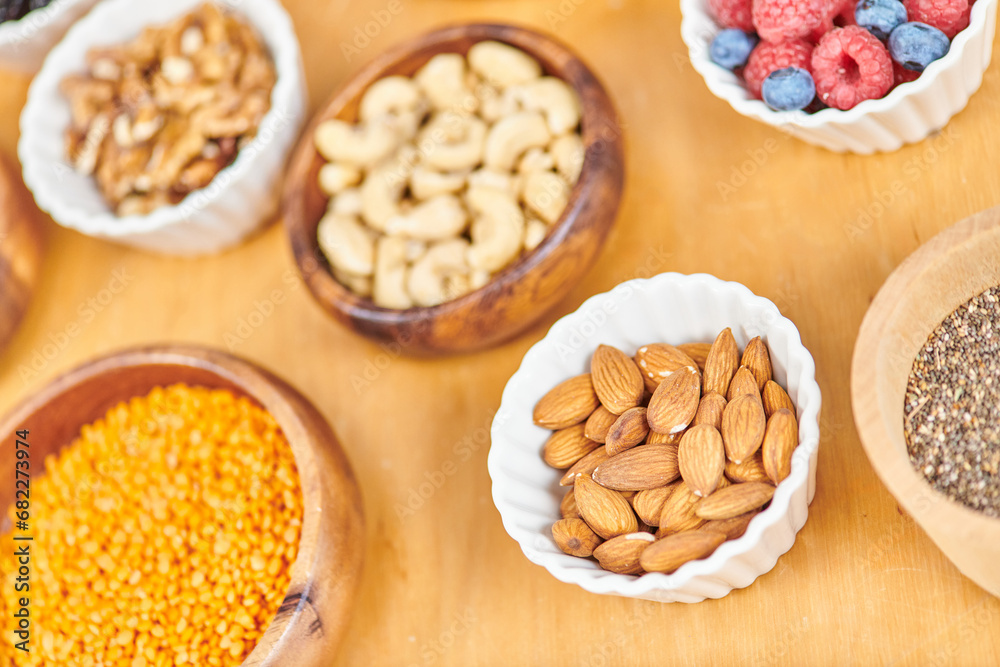 almonds and lentils near assortment of wholesome plant-based food in bowls, vegetarian concept almonds and lentils near assortment of wholesome plant-based food in bowls, vegetarian concept