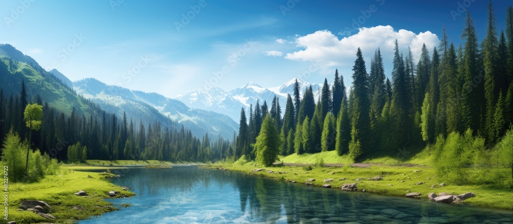 summer, as the background of the magnificent landscape, the lush green forest extended towards the towering mountains, complemented by the vibrant blue skies and shimmering water, creating a