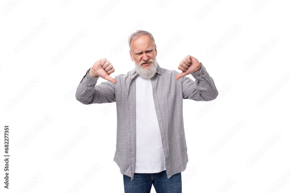 well-groomed gray-haired senior man with a beard and mustache in a shirt shows a dislike