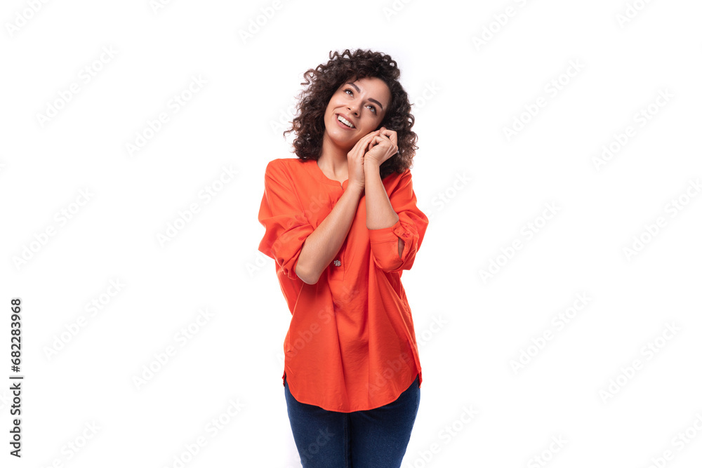 young dreamy caucasian business woman with wavy hair dressed in an orange blouse on a white background young dreamy caucasian business woman with wavy hair dressed in an orange blouse on a white background
