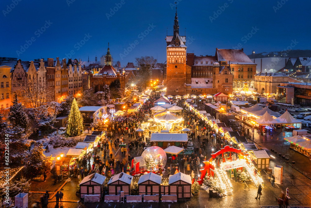Beautifully lit Christmas fair in the Main City of Gdansk at dusk. Poland - obrazy, fototapety, plakaty 